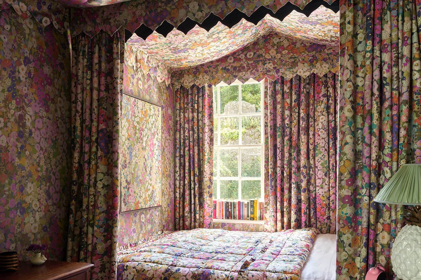 a bed with a floral curtain