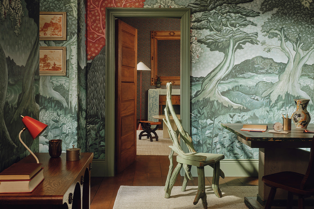 a room with a tree wallpaper and a table