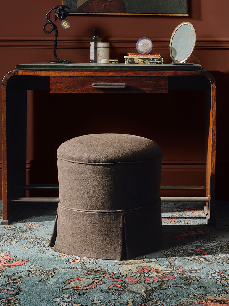 a round stool under a desk