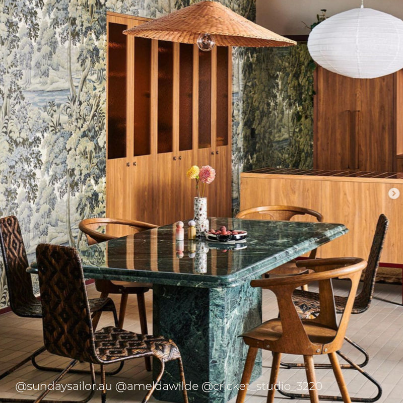 a dining table with chairs and a lamp
