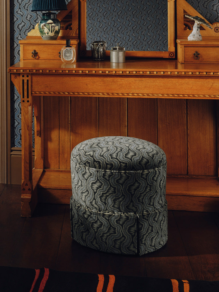 a stool next to a mirror