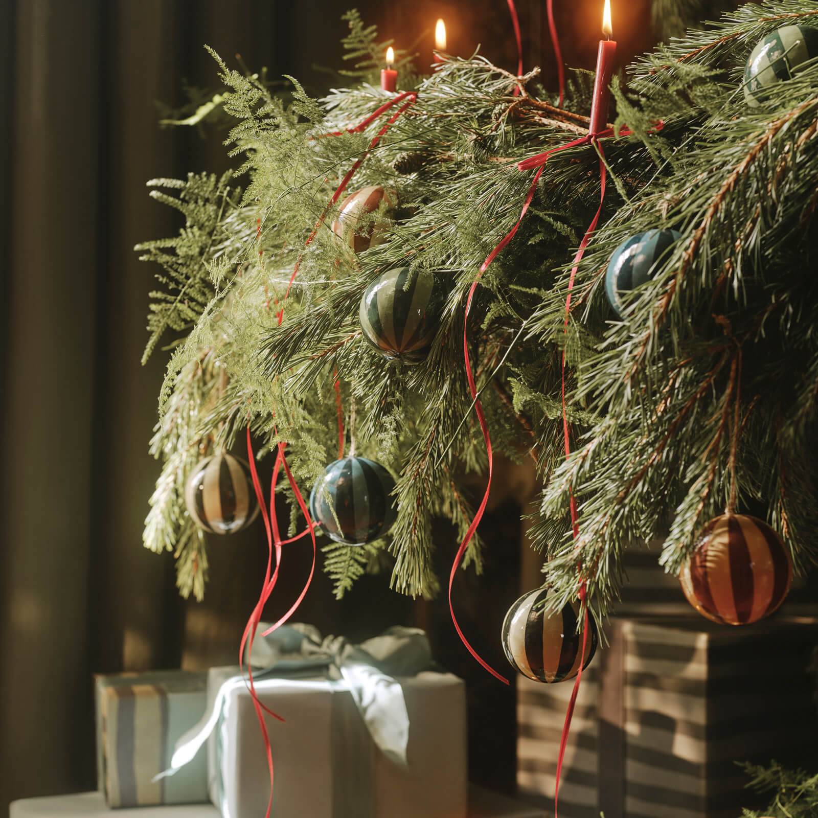 a tree branch with ornaments and presents