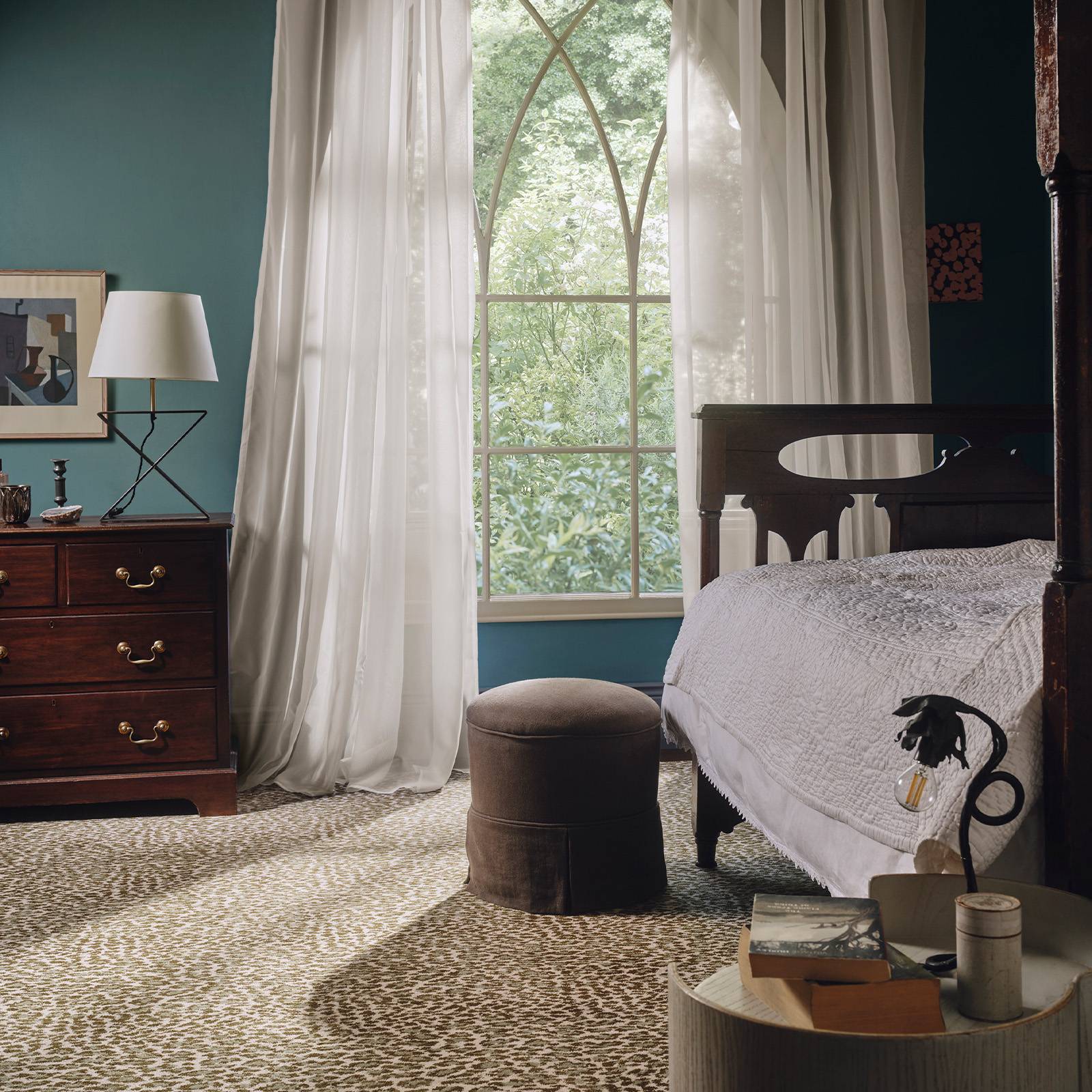 a bedroom with a bed and a round table
