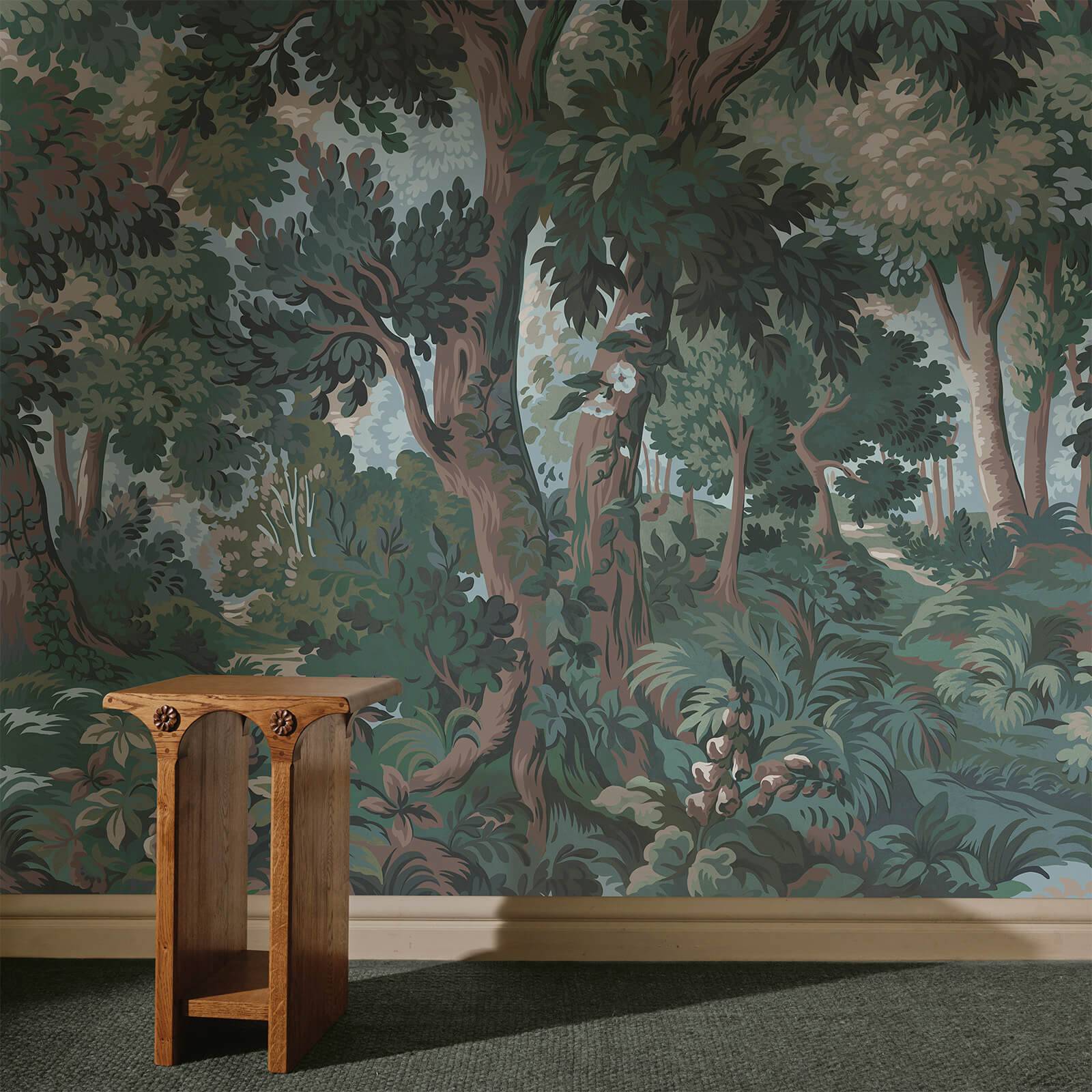 a table in front of a wall with a forest mural