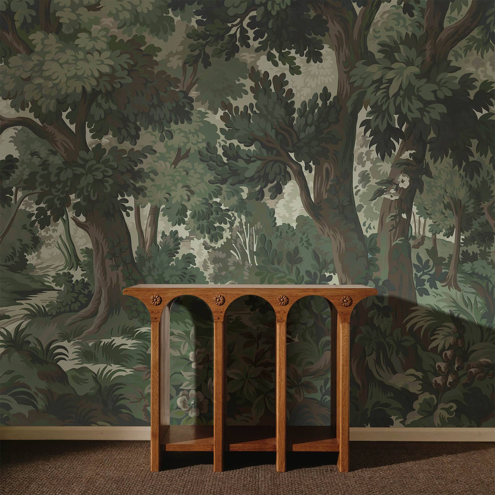 a table in front of a wall with trees on the wall