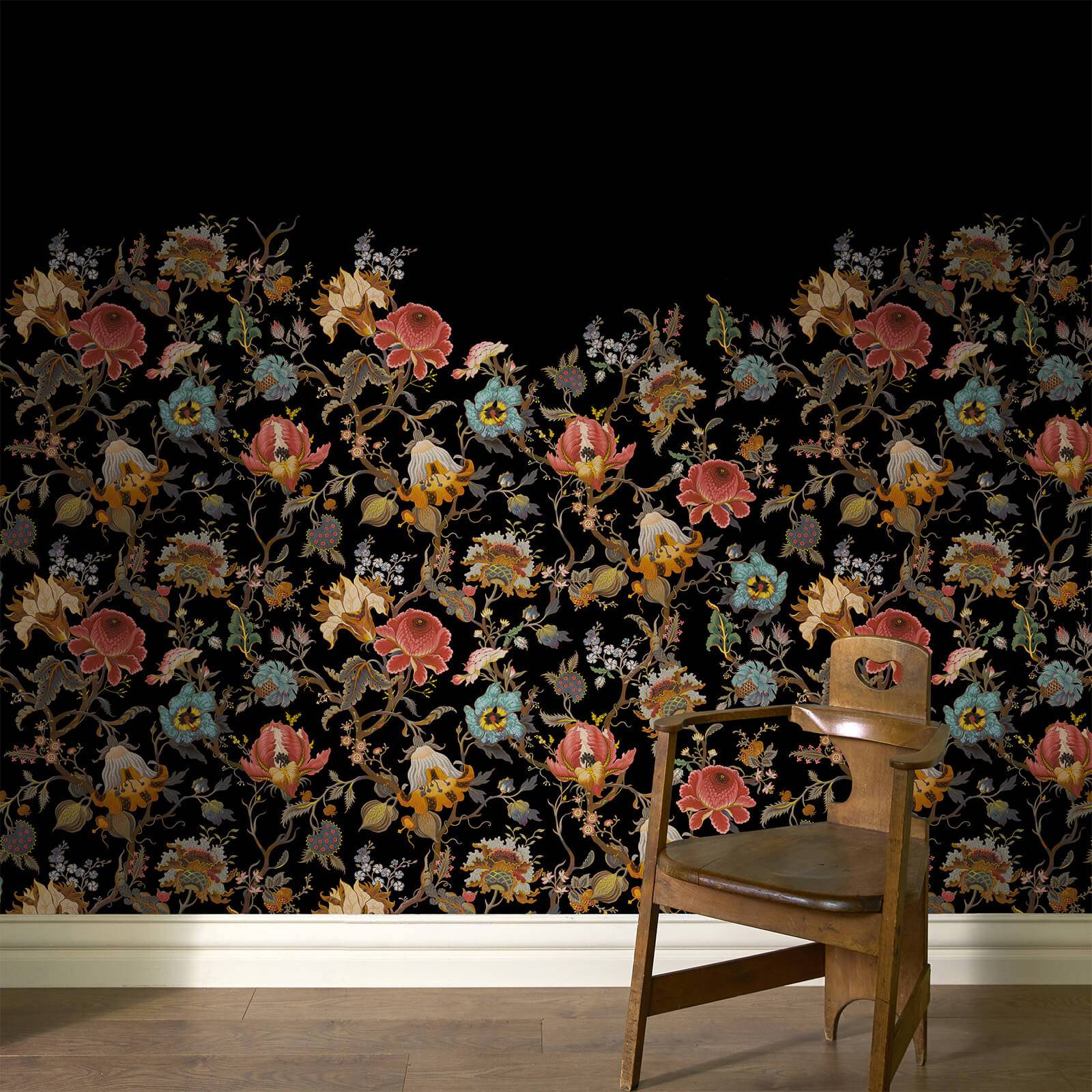 a chair in a room with floral wallpaper