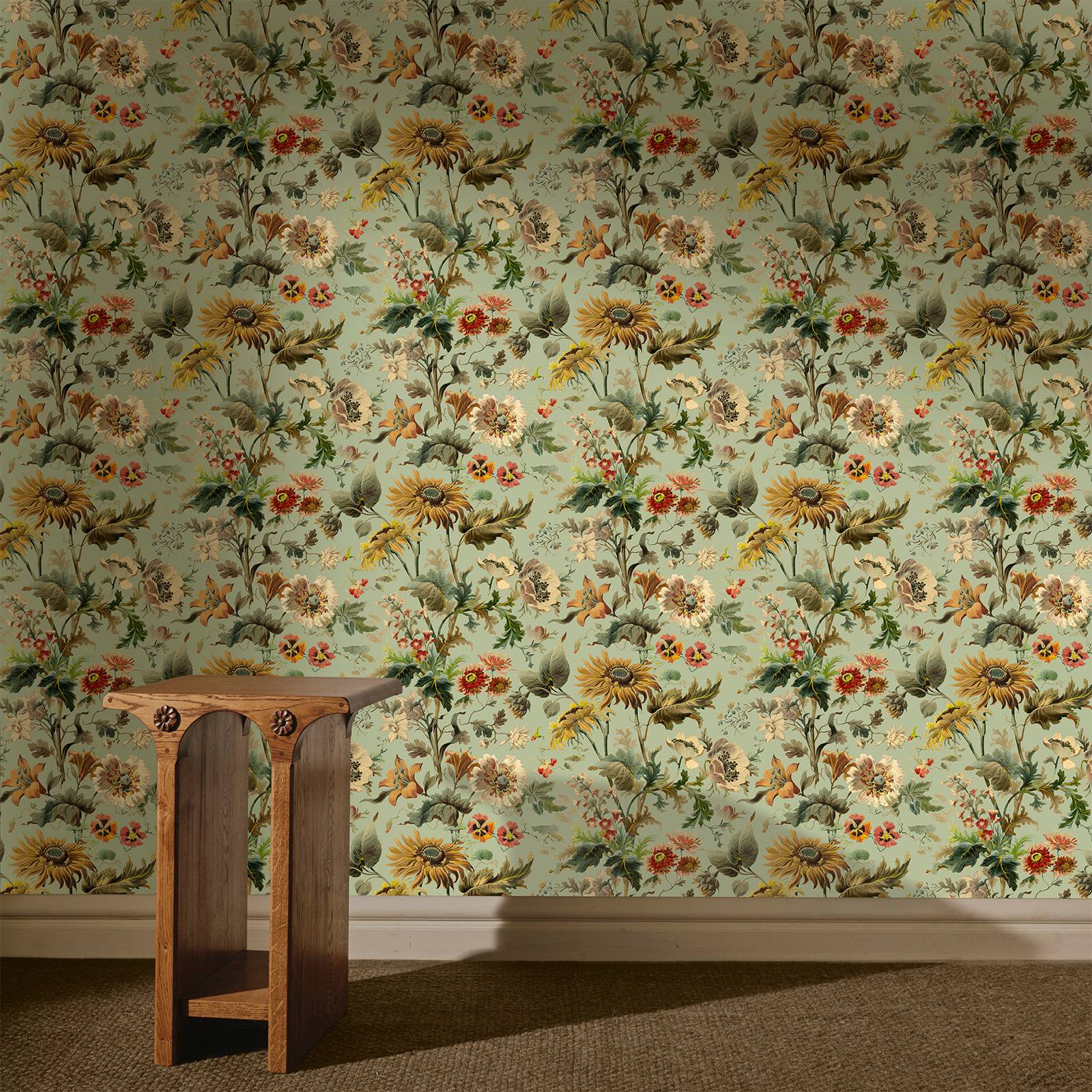 a wooden table in a room with floral wallpaper