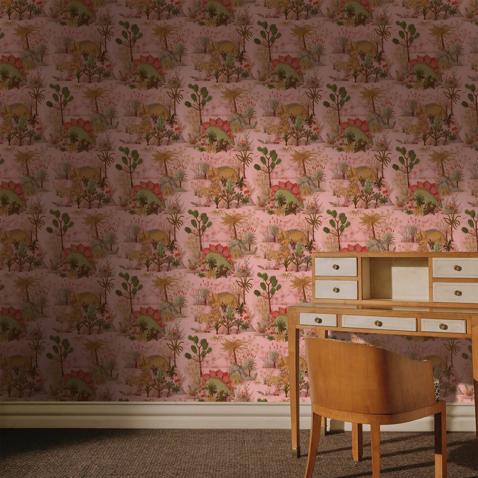 a desk and chair in a room with wallpaper