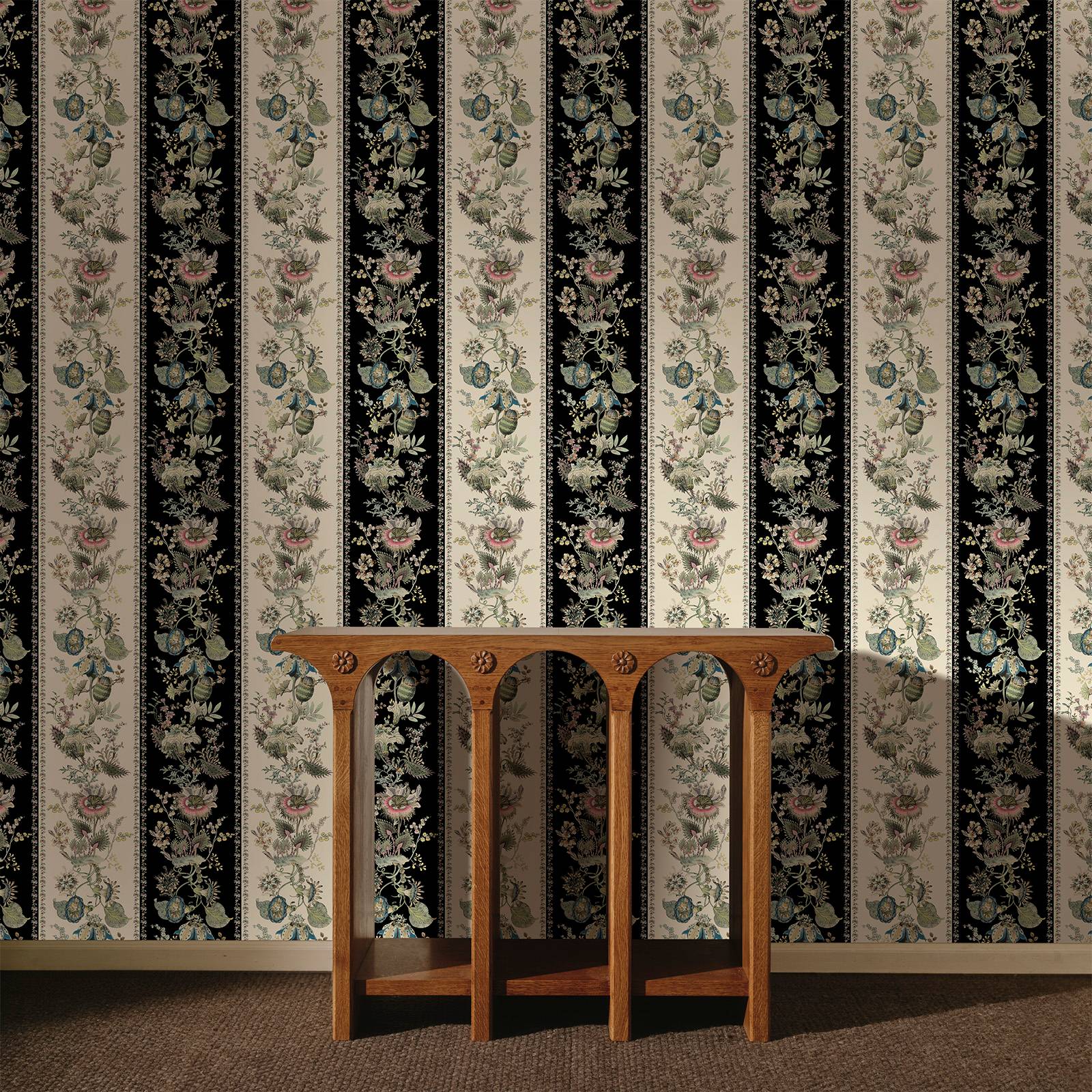 a wooden table in front of a wall with floral wallpaper