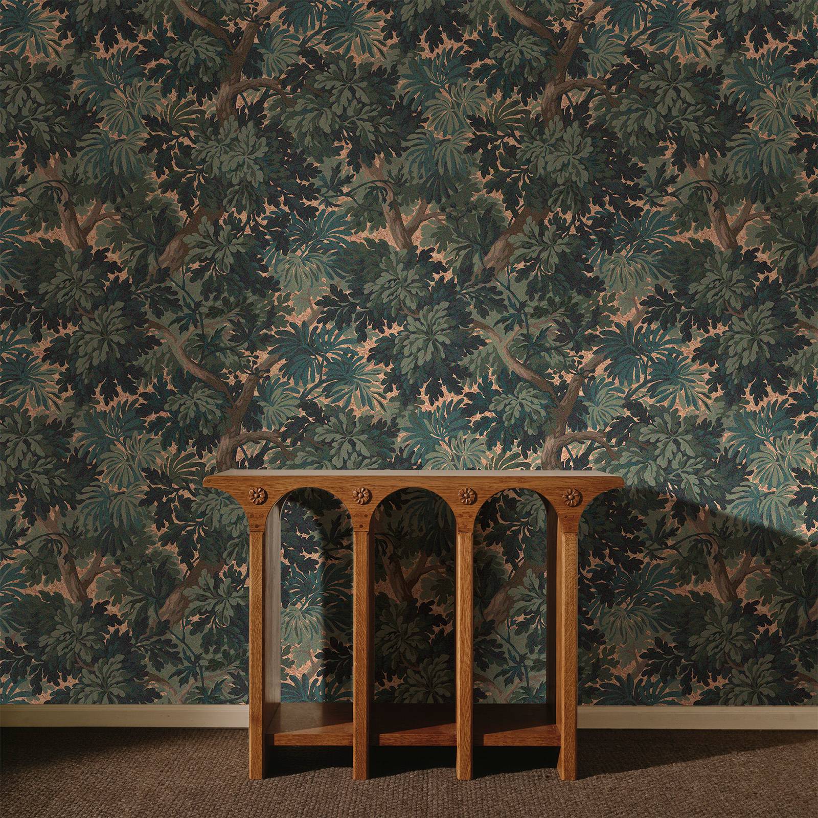 a wooden table in front of a wall with a floral wallpaper
