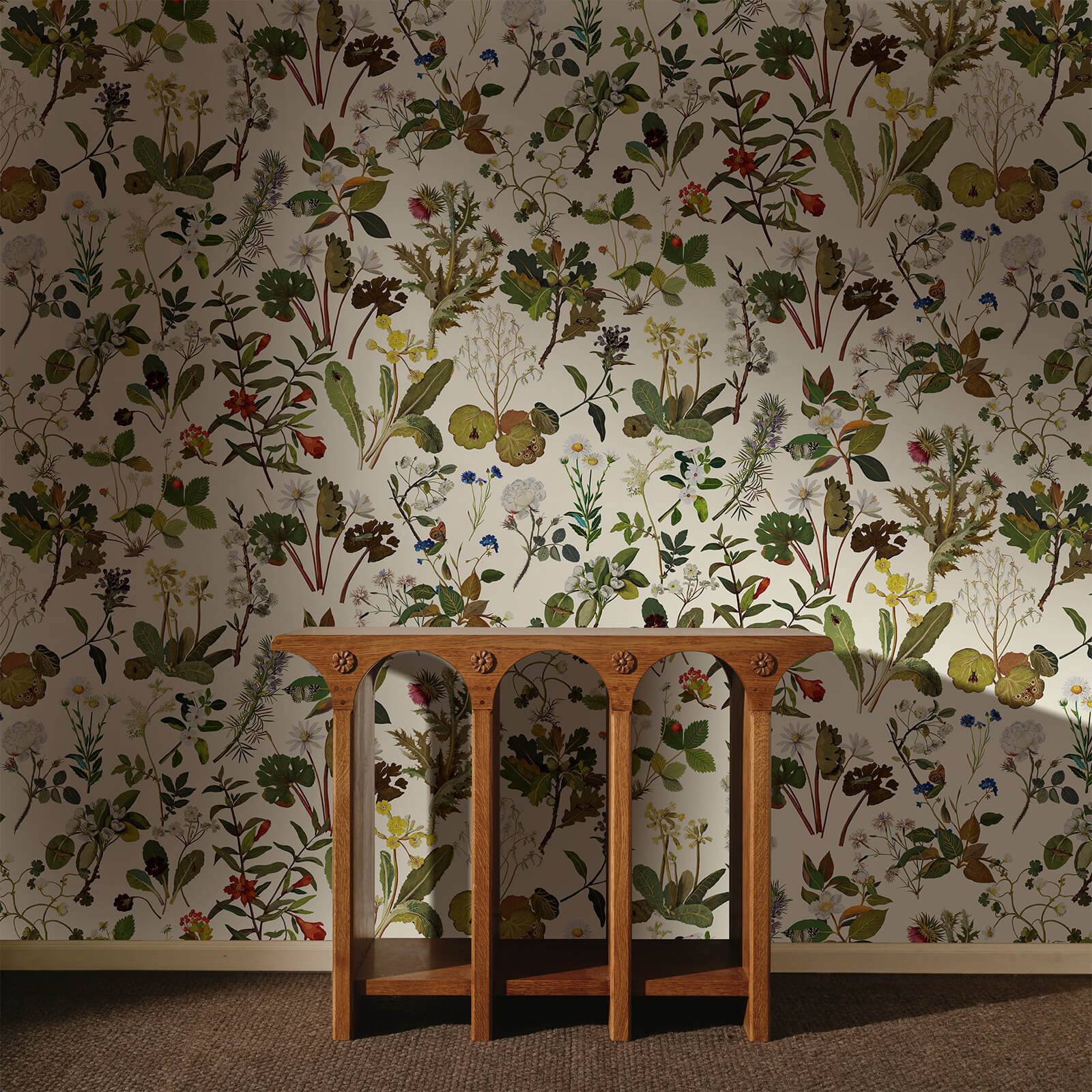 a wooden table in front of a wall with floral wallpaper