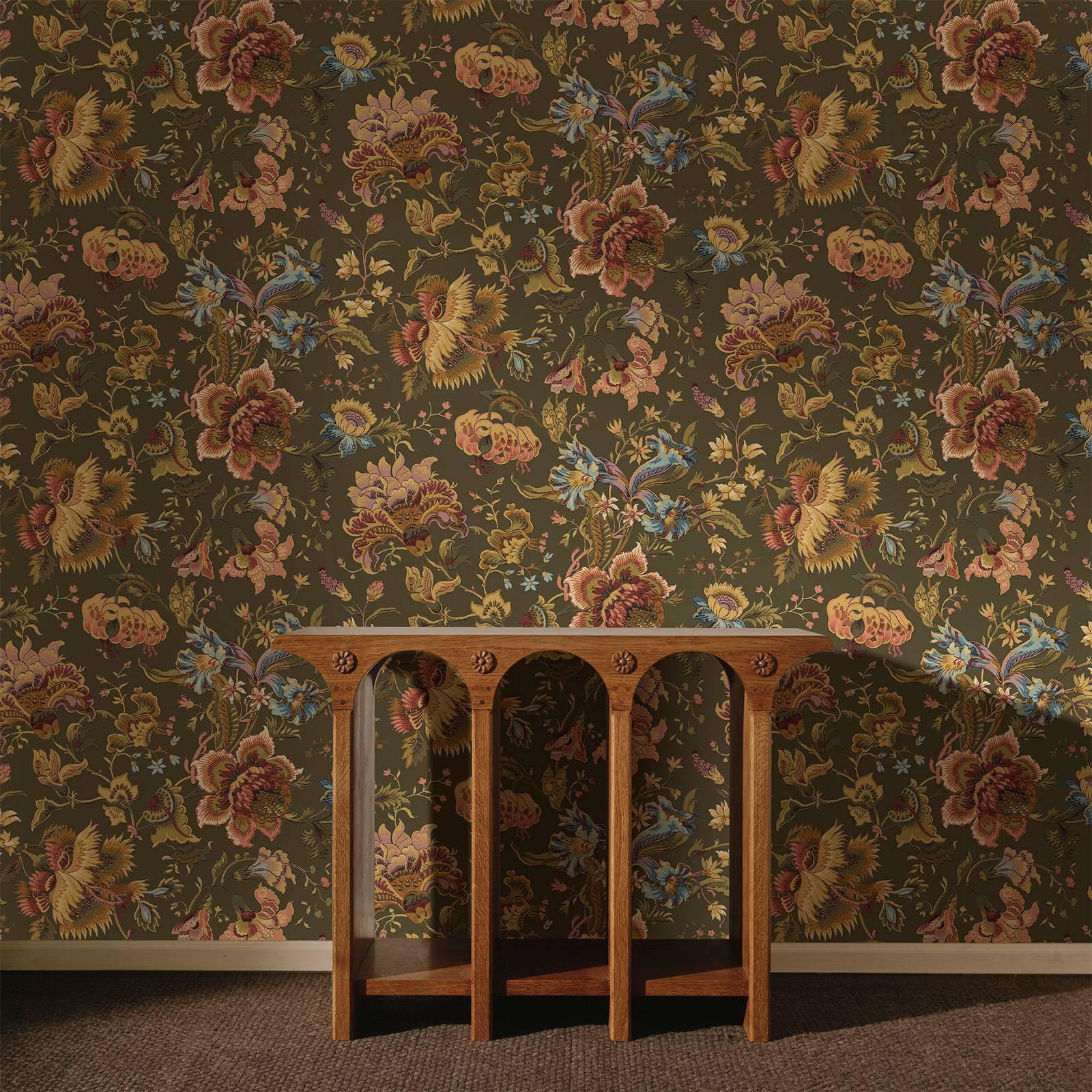 a wooden table in front of a floral wallpaper