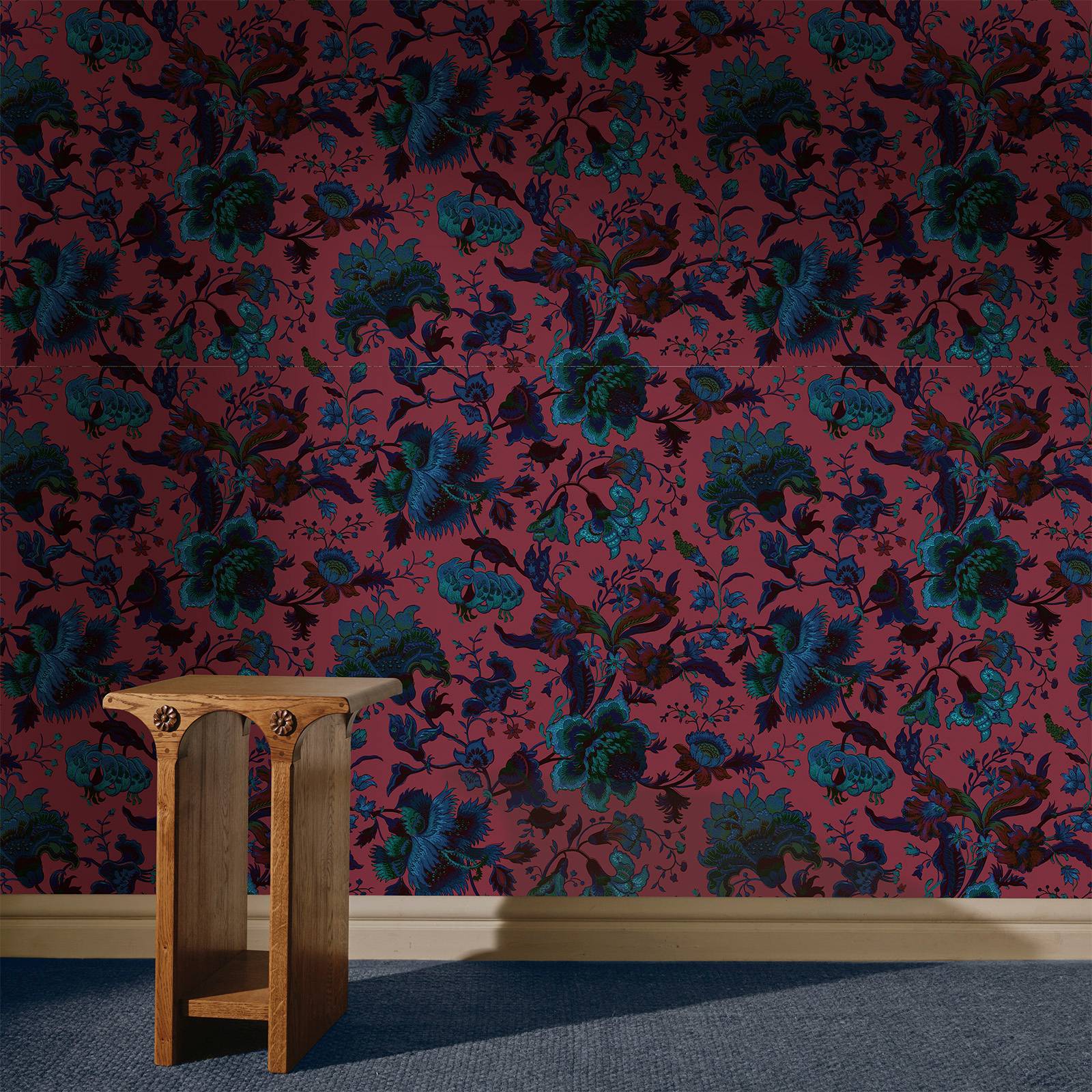 a wooden table in a room with a floral wallpaper