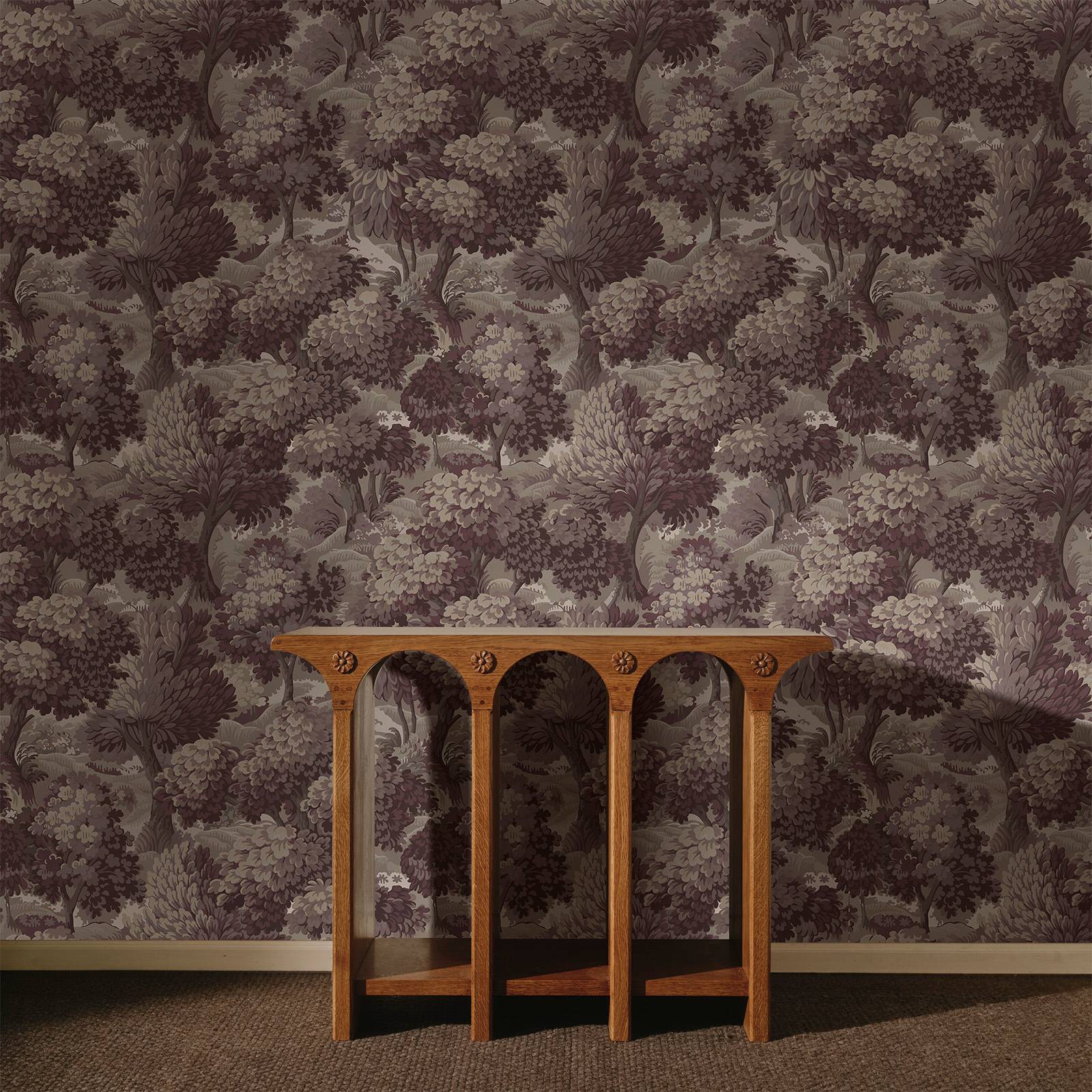 a wooden table in front of a wall
