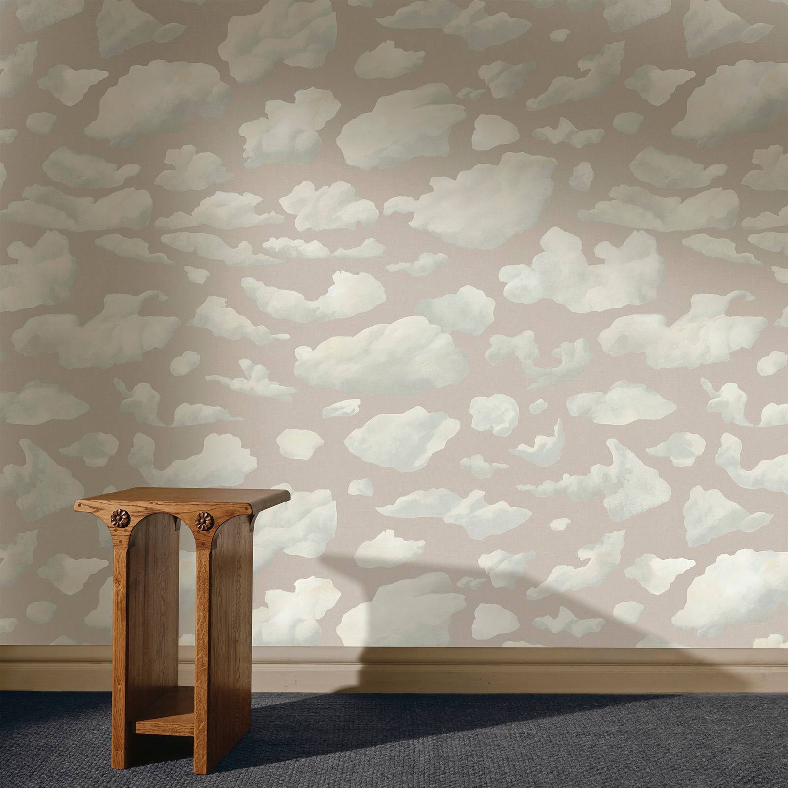 a wooden table in a room with clouds wallpaper