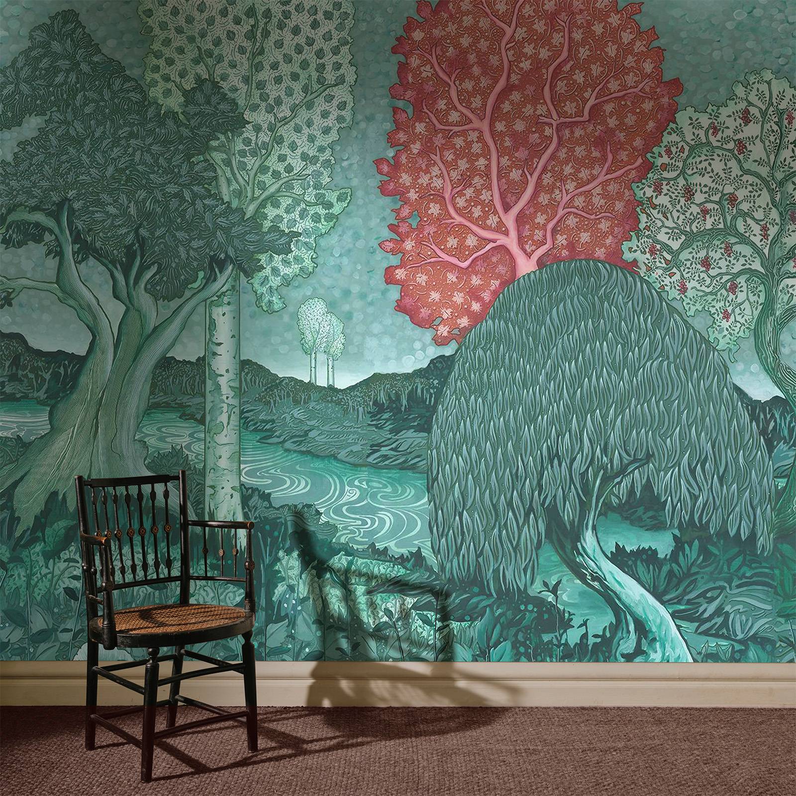a chair in front of a wall with trees and a river
