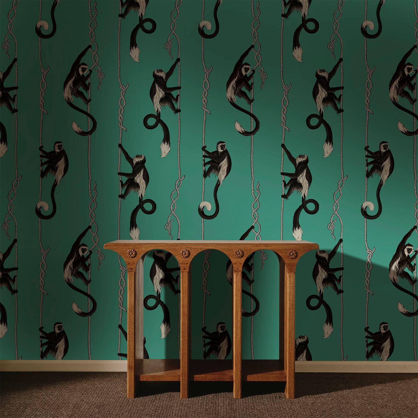a wooden table in front of a wall with monkeys on it