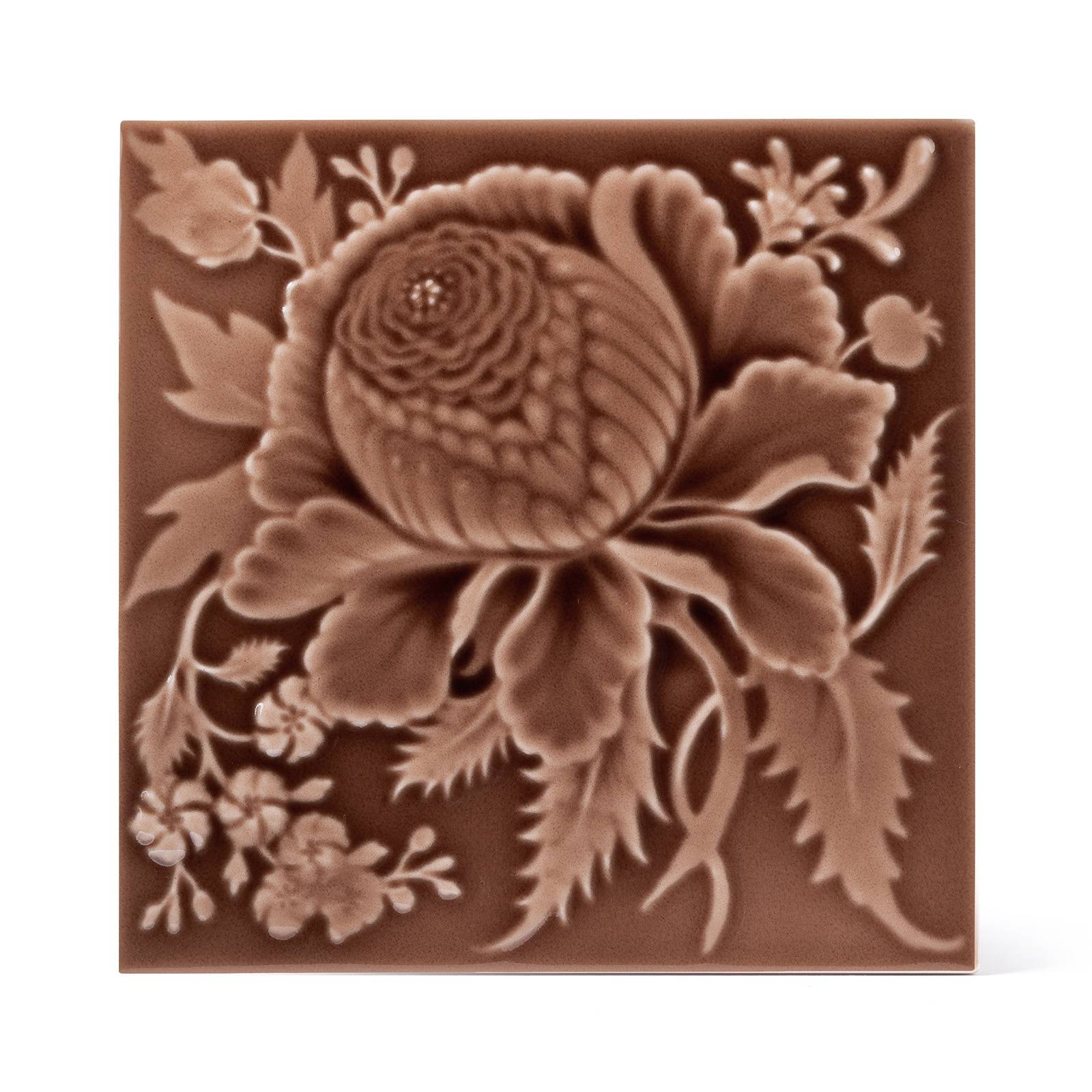 a brown tile with a flower design